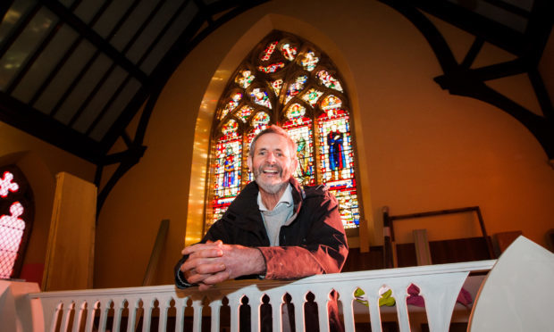 Willie Little with the stained glass window.