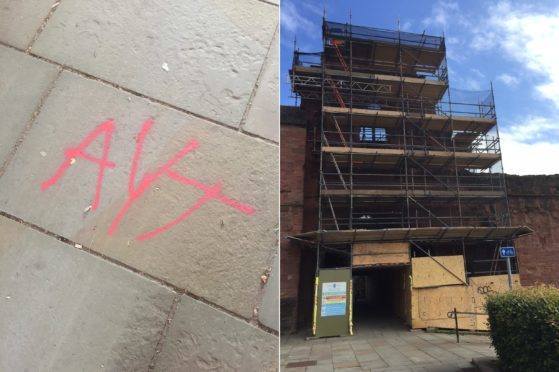 Gang logos were spray-painted on to stone floors and also higher up on the main abbey building behind scaffolding.