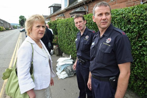 Stewart Edgar, far right, pictured with local MSP Roseanna Cunningham in Feus Road, Perth, following flooding in 2010.