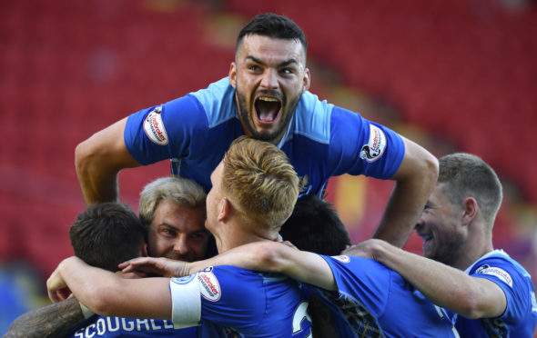 The Saints players celebrate Stefan Scougall's winner.