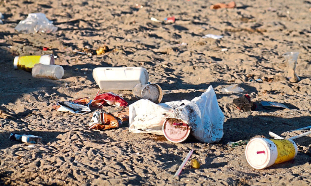 Trash left after an event on an urban beach.