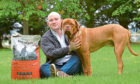 Craig Wallace of Wilsons Pet Food with puppy Bruce.