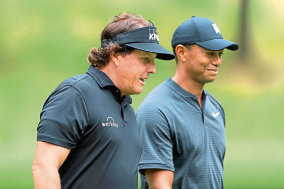 AKRON, OH - AUGUST 01:  Phil Mickelson (L) and Tiger Woods meet during a preview day of the World Golf Championships - Bridgestone Invitational at Firestone Country Club South Course at on August 1, 2018 in Akron, Ohio.  (Photo by Sam Greenwood/Getty Images)