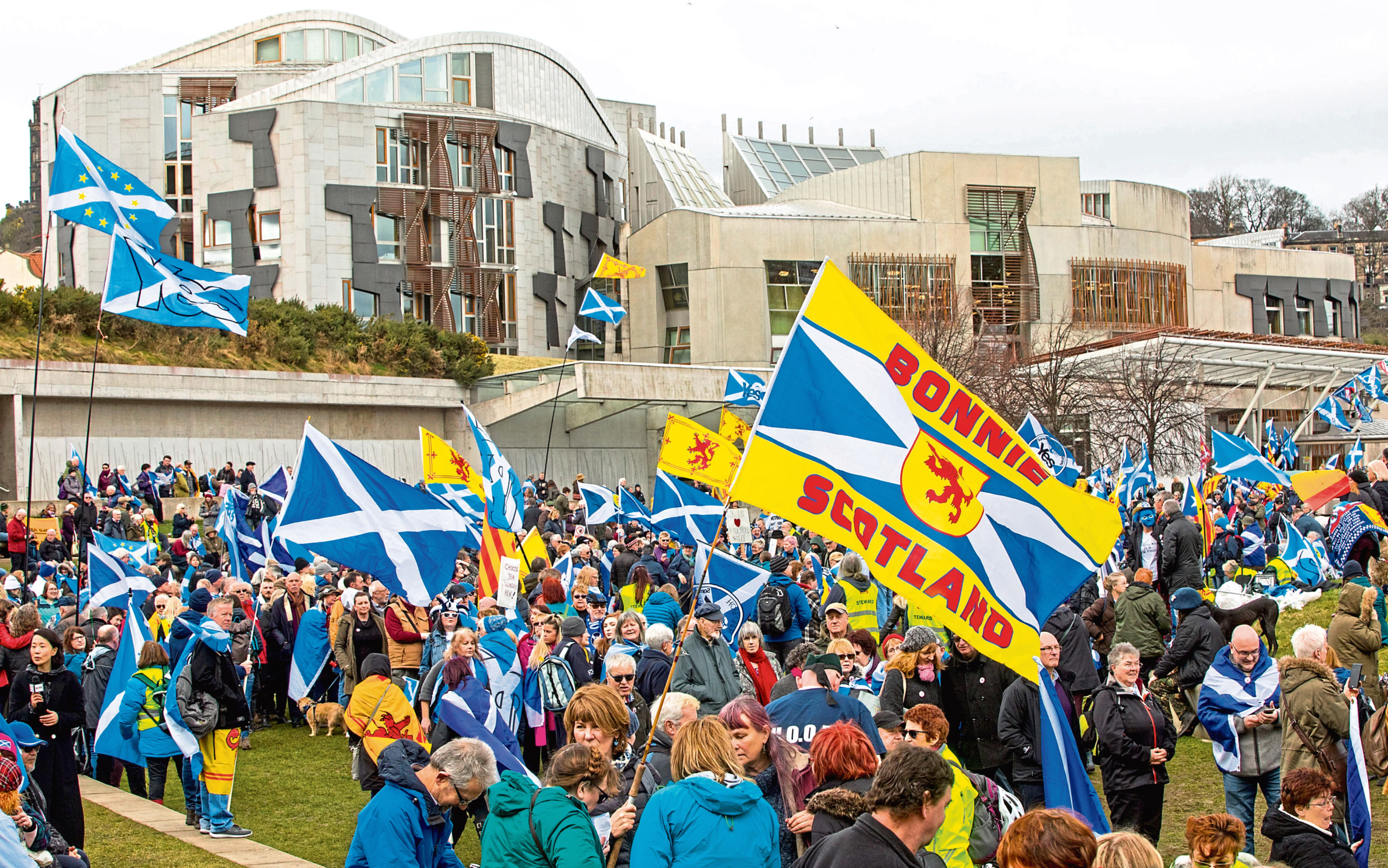 Thousands of people join Hands off our Parliament (HOOP) demo at Scottish Parliament. The demonstration surrounded Holyrood with a living chain of hands. March 23 2018