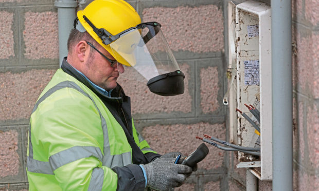 An SSE technician works on a household supply connection.