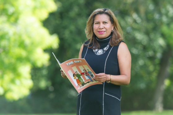 Mayra Crowe with a copy of The Gift