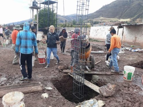 Volunteers help to build a new shower block dedicated to a former resident