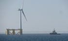 The offshore wind turbine makes its way down the Tay.