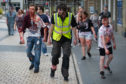 Zombies walk through Meadowside on Saturday