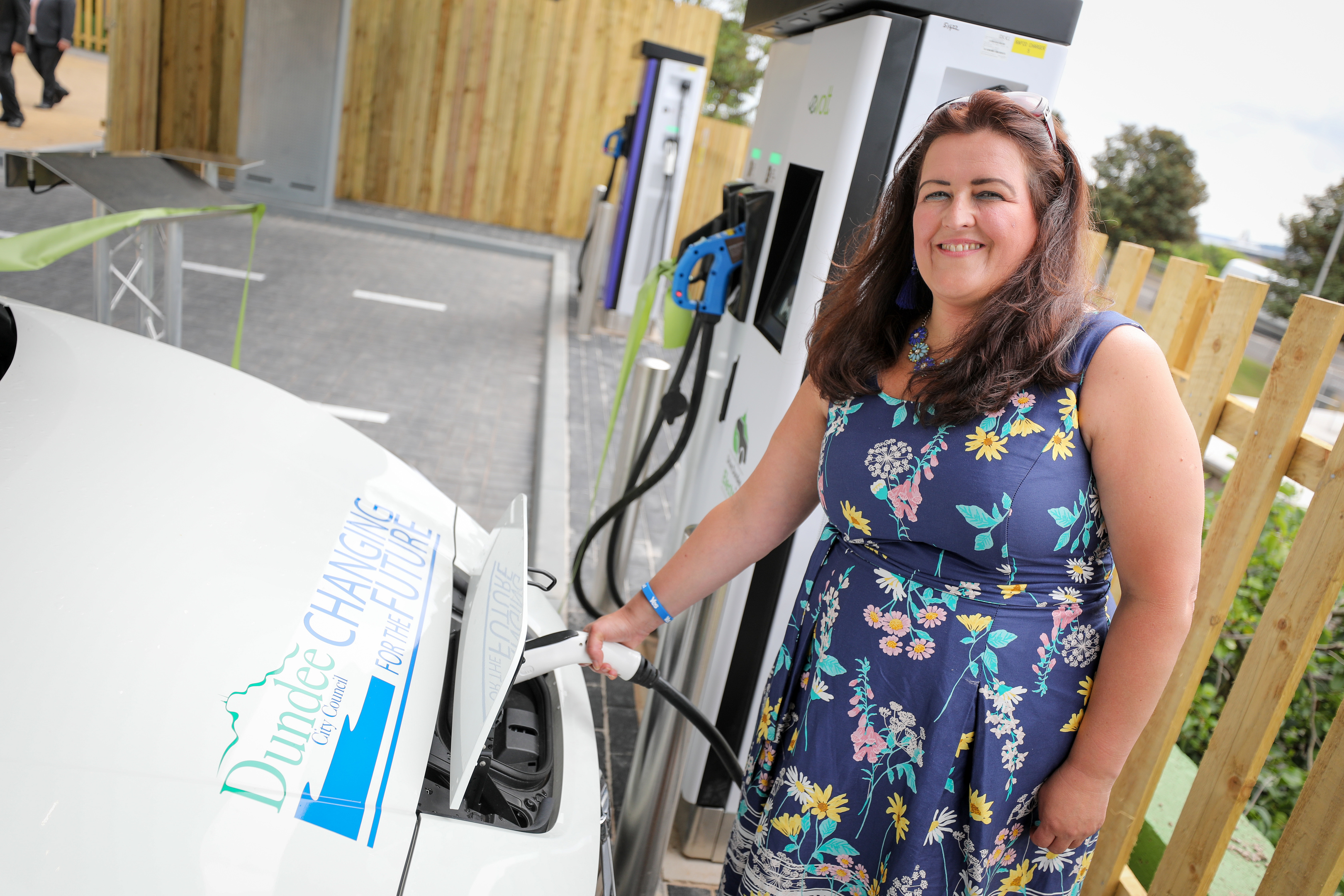 The council's city development convener Lynne Short by an electric vehicle in Dundee.