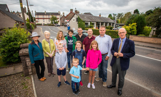 John Swinney MSP (far right) alongside Kevin Stirling (Safer Meigle Campaign Group) and local residents in the centre of Meigle. Alyth Road, Meigle A94.