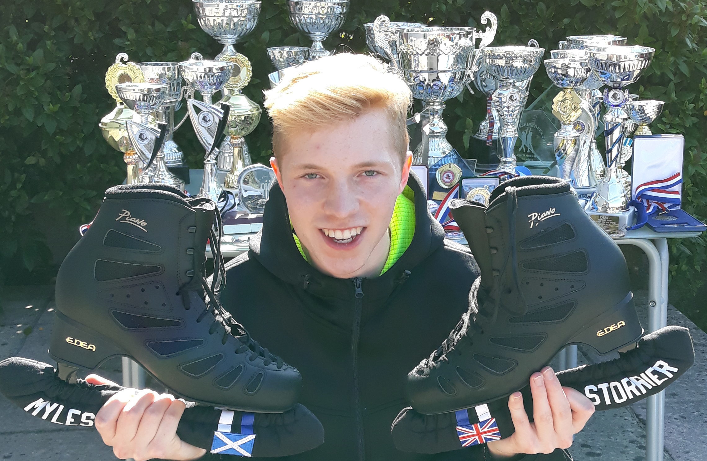Myles Storrier with his skates and trophies.