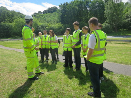 Pitlochry teens installing the hotels with Transport Scotland staff.