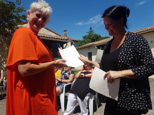 Dawn (left) receives her certificate.