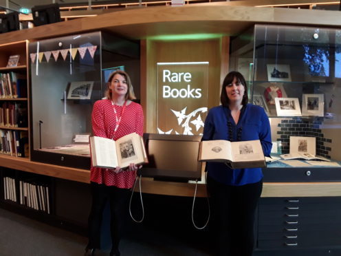 Sara on the left and Cassie with the book