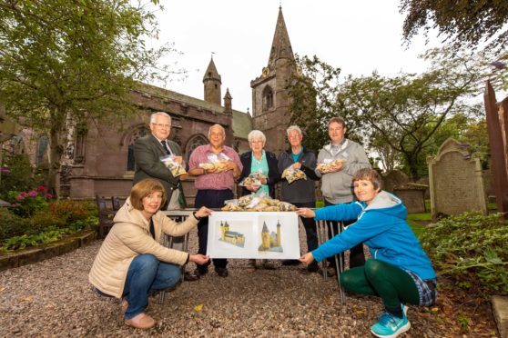 Claire Scrimgeour, Stanley Callaghan, Steve Dempsey, Irene Gillies, George Mitchell, Gordon Strachan and Caitlin McIlroy with the lego pieces to build the Lego Brechin Cathedral.