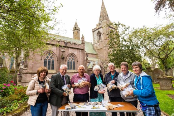 Claire Scrimgeour, Stanley Callaghan, Steve Dempsey, Irene Gillies, George Mitchell, Gordon Strachan and Caitlin McIlroy with the pieces to build the Lego Brechin Cathedral.