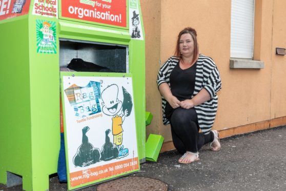 Administrator Lisa Gray at the clothing bin