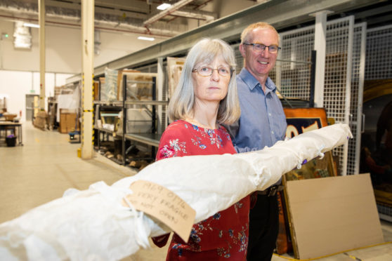 Lesley Botten (Interpretation Team Leader) and Gavin Grant (Collections Team Leader) with the banner