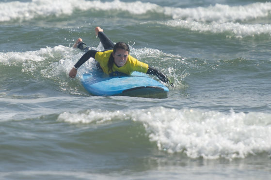 Gayle gets the hang of surfing at West Sands, St Andrews.