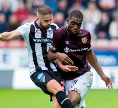 Dunfermline's Danny Devine in action against Hearts' Uche Ikpeazu.