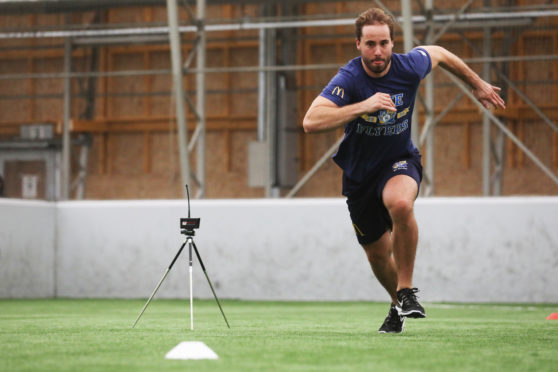 Brett Bulmer of Fife Flyers doing a fitness test drill with timing monitors.