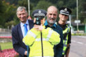 Councillor for the Highland Ward Mike Williamson, Pat Spicer of the Aberfeldy Community Council and Gordon Thomson of Police Scotland with  Pop Up Jim.