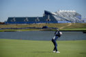 French Open champion Alex Noren hits on the 15th hole of Le Golf National with a huge 1st tee stands in the background.