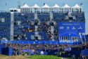 Rory McIlroy tees off in front of the massive grandstand at the first hole at Le Golf National.