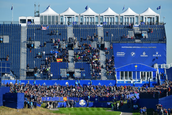 Rory McIlroy tees off in front of the massive grandstand at the first hole at Le Golf National.