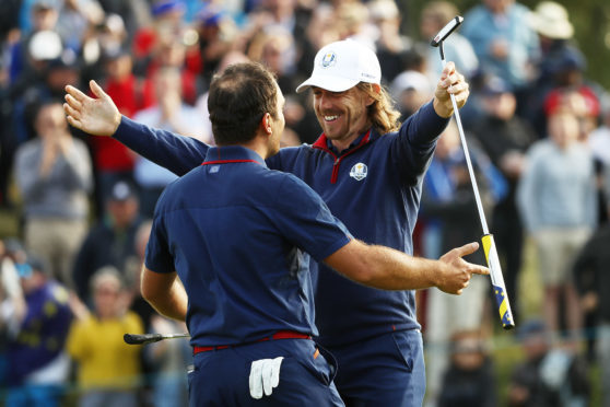 Francesco Molinari and Tommy Fleetwood celebrate after completing the 4-0 foursomes whitewash for Europe in the Ryder Cup in Paris.