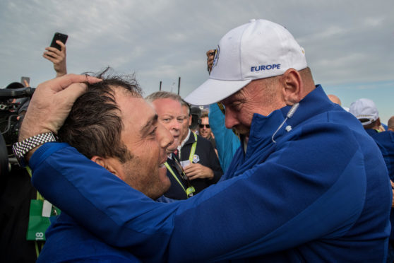 Captain Thomas Bjorn hugs Francesco Molinari as he secures the winning point to take the victory during the singles matches of the 2018 Ryder Cup.