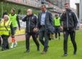 Dundee United manager Csaba Laszlo (centre) walks down the touchline at full-time, with boos ringing out from the home stands.