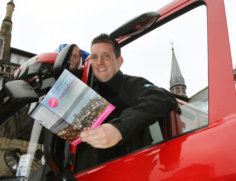 Fireman Martin Lannan from Blackness Fire station which is taking part in the event on the open door of his fire engine.