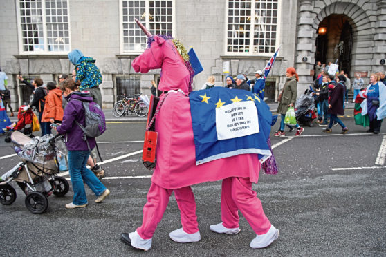 Demonstrators dressed as the "Brexit Unicorn" take part in the March For The Many, calling for a people's vote on the final outcome of the government's Brexit negotiations, during the first day of the annual Labour Party conference.