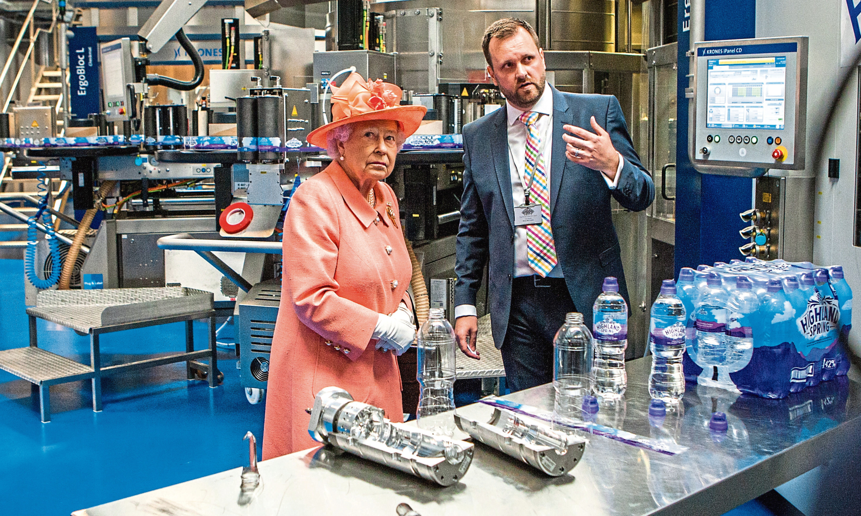 Courier News - Perth - Richard Burdge Story. The Queen visits Highland Spring factory, Blackford. Picture shows The Queen getting a demonstration from Bryan McCluskey (Group Operations Director). Highland Spring, Stirling Street, Blackford. Thursday 6th July 2017.