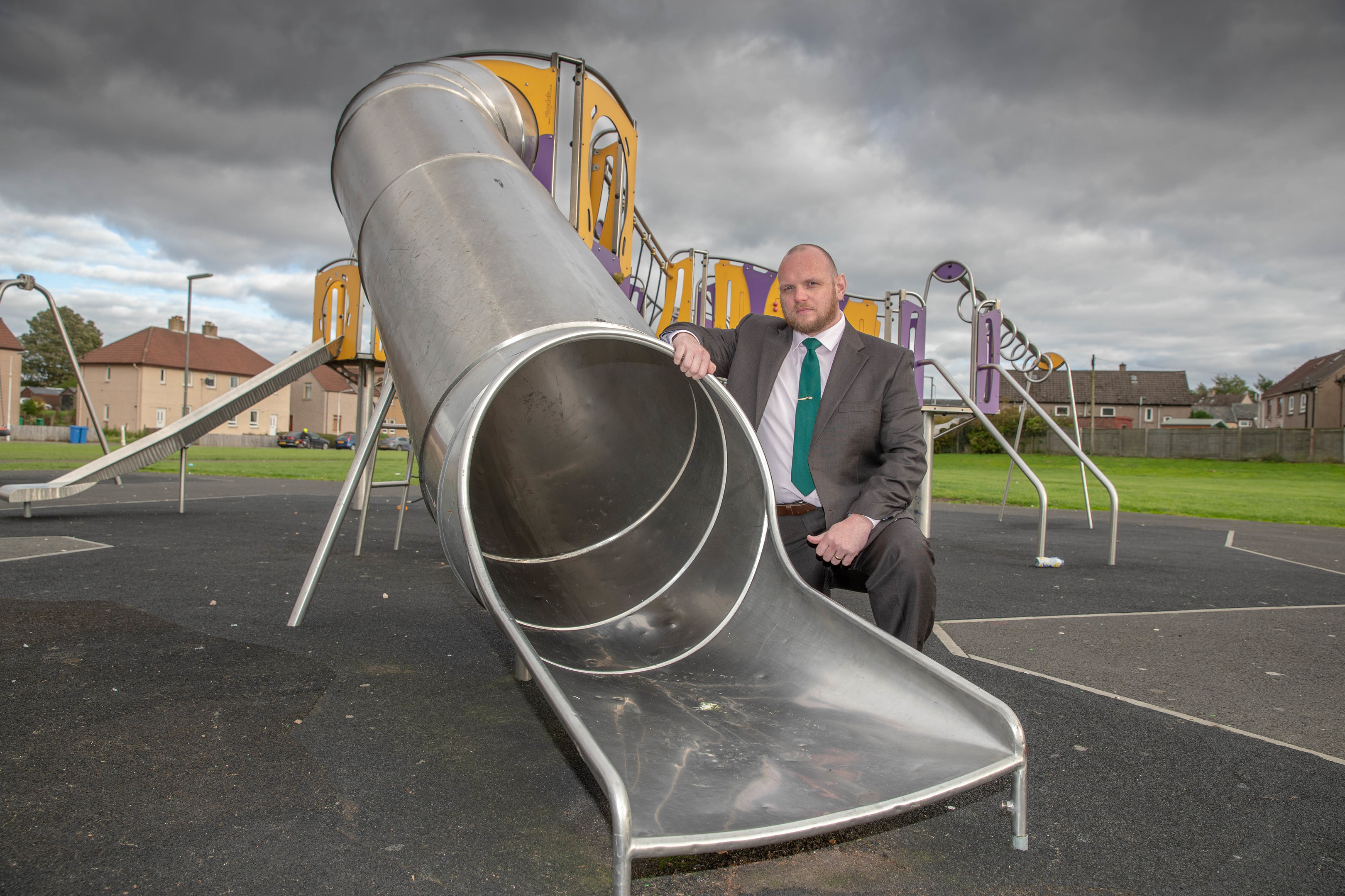 Councillor Darren Watt beside the slide targeted by vandals.