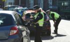 Police talking to motorists who were driving through Albert Square in Dundee on Monday