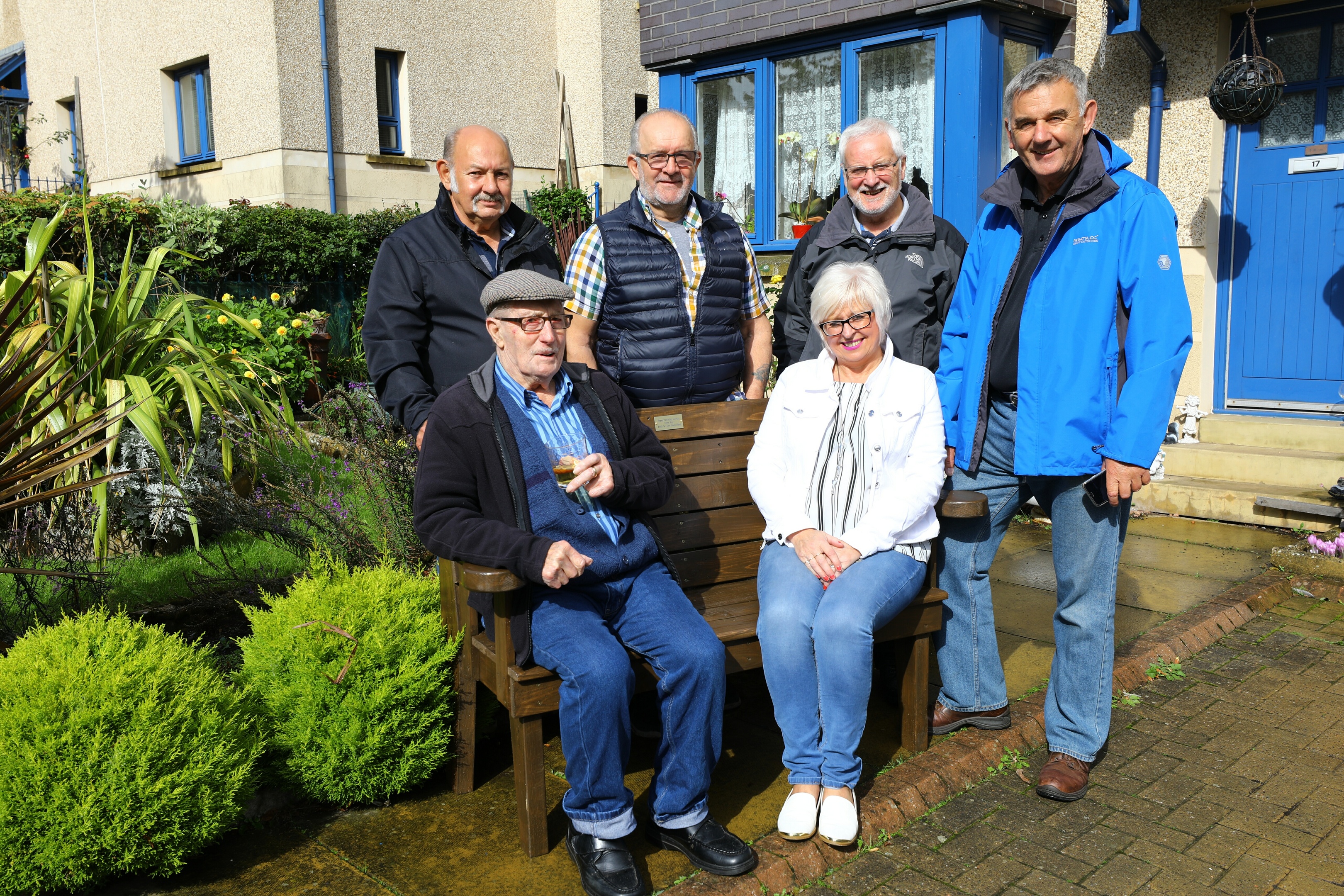 George Wilson, seated left, on his new bench from the Arbroath Men's Shed, with Kay Sturrock and back L/R, John Pearson, who made the bench, Steve Charlton - Treasurer and Jim Christie - Chairman of the Arbroath Men's Shed.