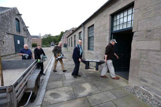 The Stanley men's shed team hard at work moving in.