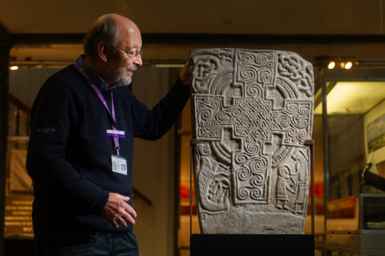 Angus Alive museums, galleries and archives collections officer John Johnston with the Inchbrayock Stone, Montrose Museum.