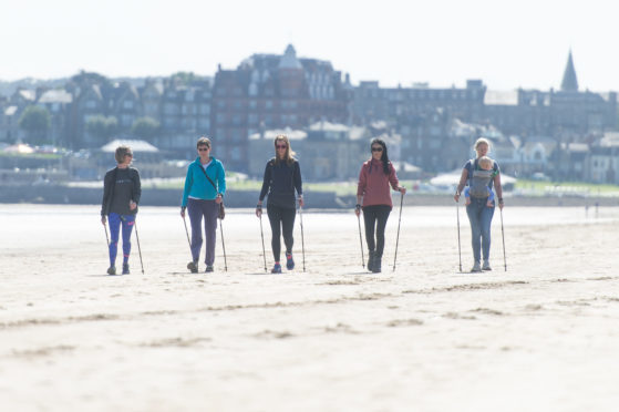 Nordic walking along the beach at West Sands. L-R Sam Mace (instructor), Helen Kermode, Claire McIntyre, Gayle and Cicely Threlfall and Isaac (10 mths).