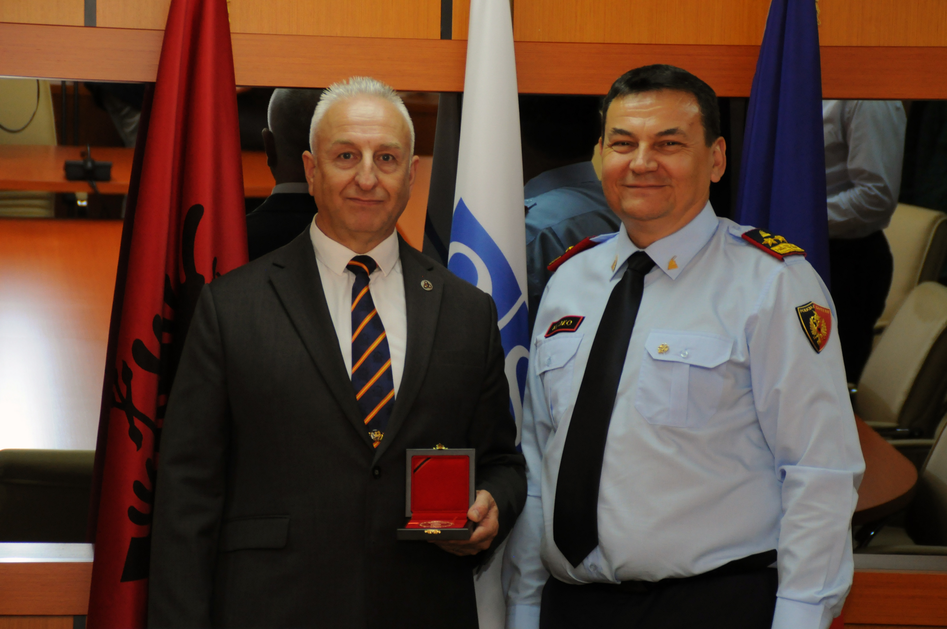 Adrian Nessel, left, receives his award in Albania