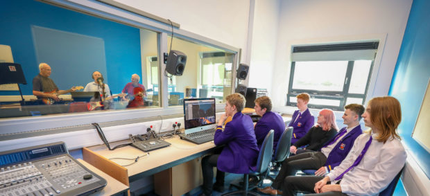 Kinross High pupils recording in their new studio with Sabres performing