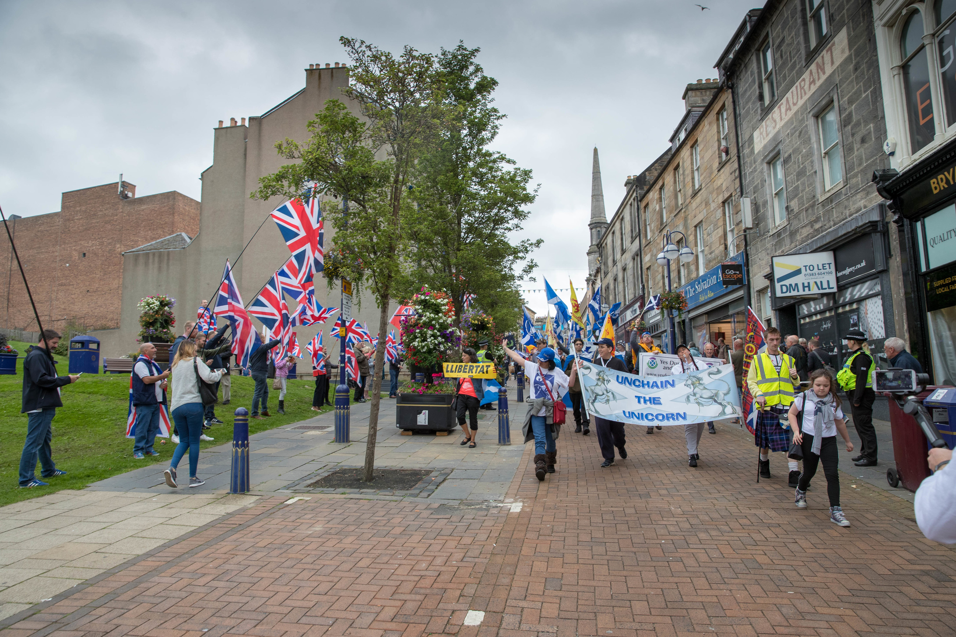 The Forward as One second annual Parade and Rally for Scottish Independence  in Dunfermline heads down the High Street towards Pittincrieff Park past a small gathering of Unionists.