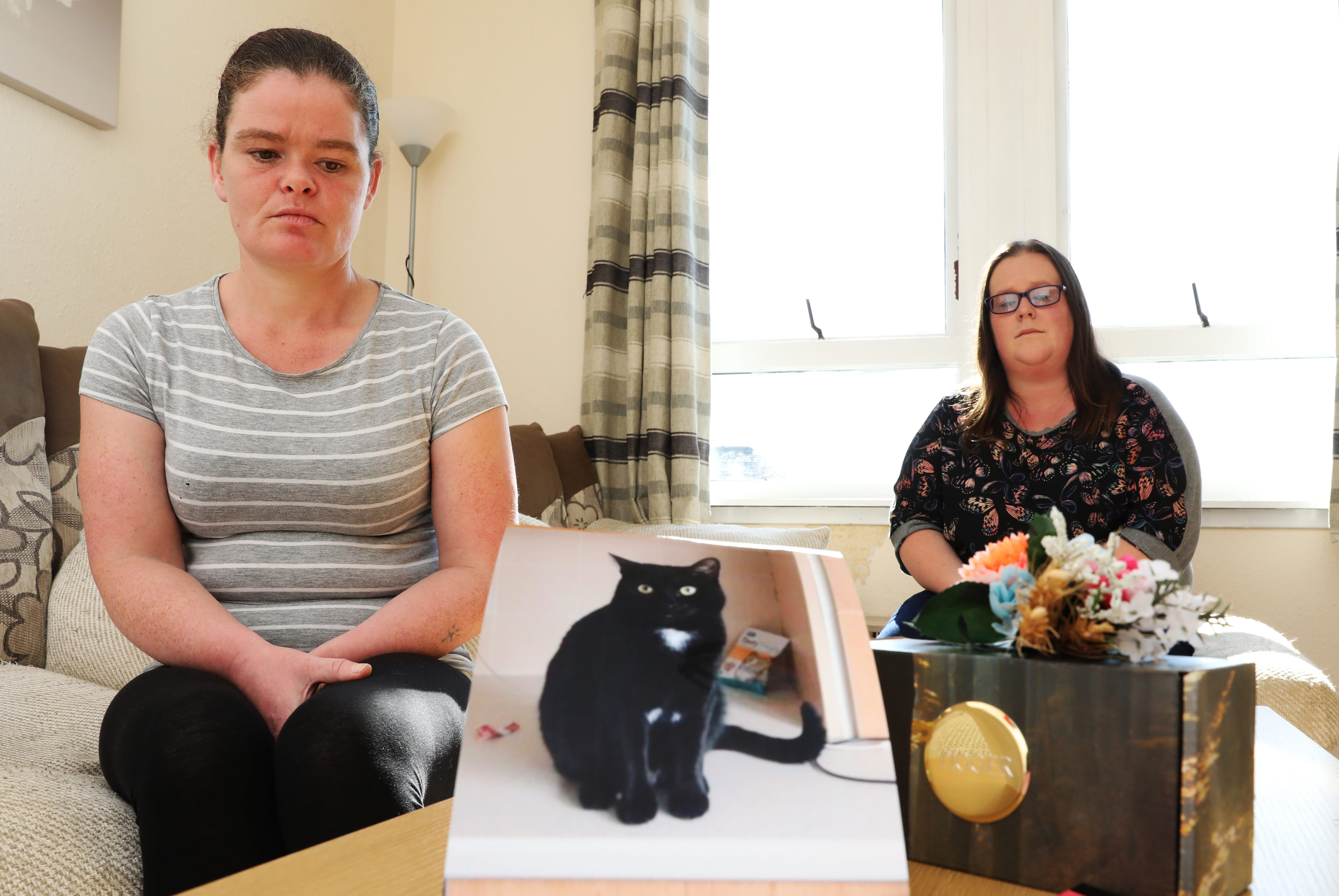 Lorna Ogilvie and Michelle Williamson with pictures of Sylvester, 3 who was run down on Wednesday and the ashes of Tigger who was run down last year.