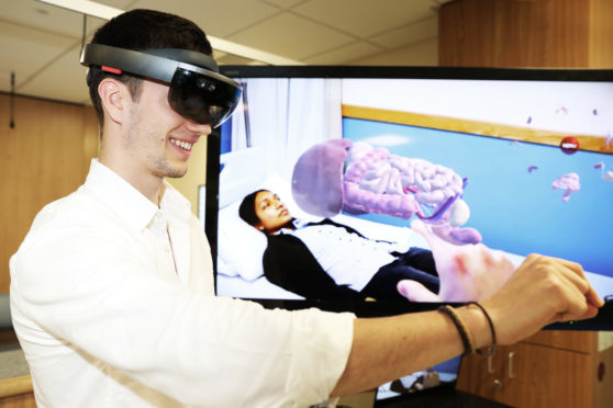Virtual reality headsets and interactive anatomy stations are among the hi-tech innovations that feature in a new medical education training centre developed by the University of Dundee, NHS Tayside and industry partners Medtronic. Picture shows; Javier Suquia, Co-Founder of Immernova with Shereen Kadir posing as a patient, University of Dundee's Medical Artist and Content Developer.