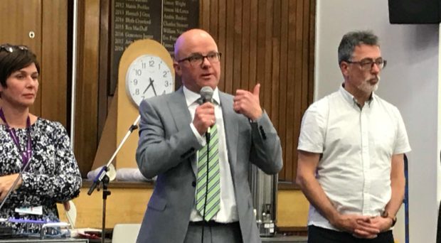 Michael Kellet, centre, addresses a St Andrews meeting.