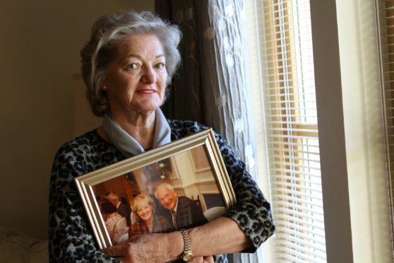 Elizabeth Birrell with a photo of her husband Ian.