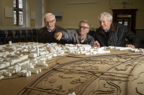 Sandy Munro, Raymond Sutton and John MacPherson of the Montrose Society study the 3D model on display at the town’s library.